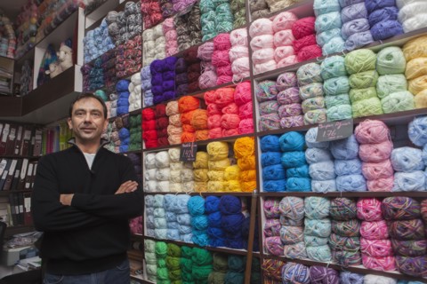 Mixed Race man posing at yarn store