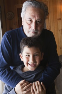 Portrait of smiling Hispanic grandfather and grandson