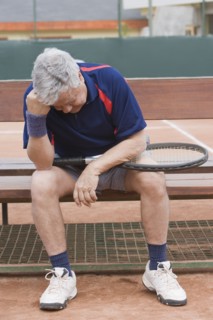 Senior Hispanic man unhappy after tennis game