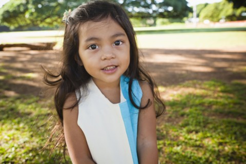 Smiling girl standing outdoors