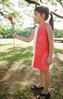 Mixed race girl holding exotic flower