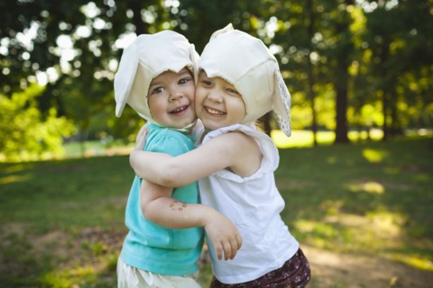 Smiling girls in mouse costume hugging