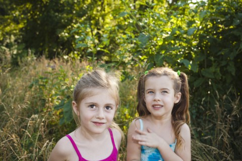 Caucasian girls standing in woods