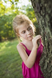 Caucasian girl looking at tree
