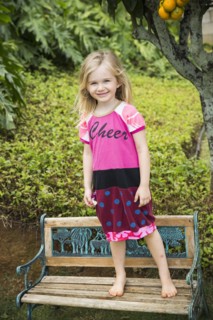 Smiling girl standing on park bench