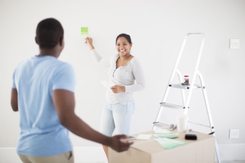Couple painting room in new home