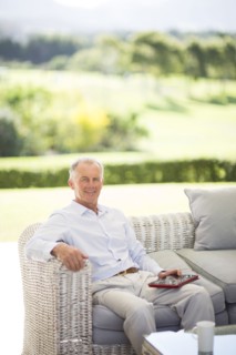 Caucasian man using digital tablet on sofa outdoors