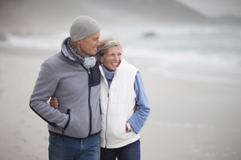Caucasian couple hugging on beach