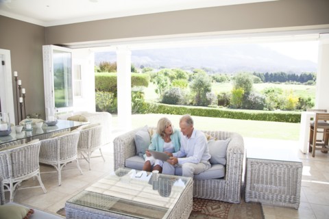 Caucasian couple using digital tablet on sofa