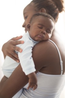 Close up of Black mother holding sleeping baby