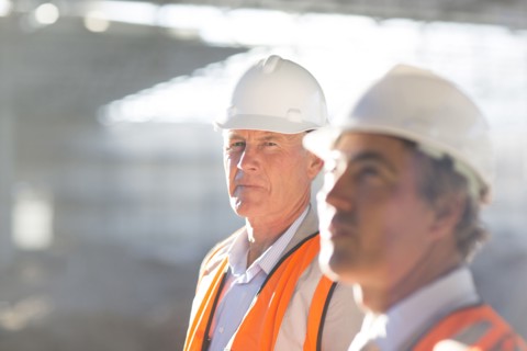 Caucasian architects standing at construction site