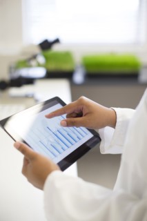 Mixed race scientist using digital tablet in laboratory