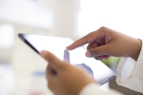 Mixed race scientist using digital tablet in laboratory