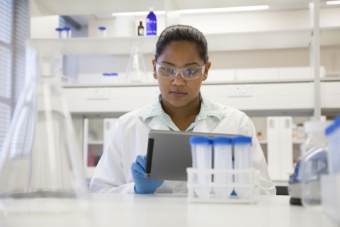 Mixed race scientist using digital tablet in laboratory