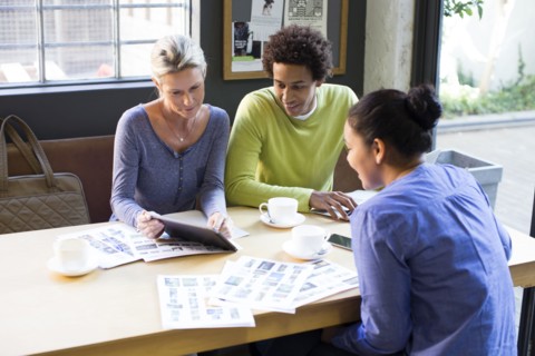 Business people using digital tablet in office meeting