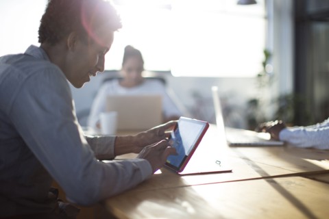 Mixed race business people using technology in office