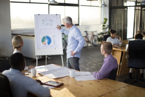 Businessman giving presentation in office meeting