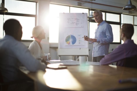 Businessman giving presentation in office meeting