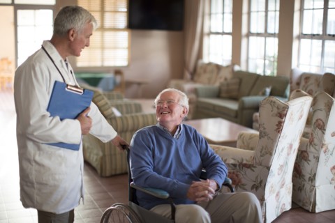 Doctor talking to patient in wheelchair