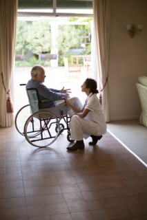Nurse talking to patient in wheelchair