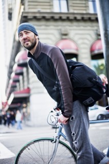 Caucasian man riding bicycle in city