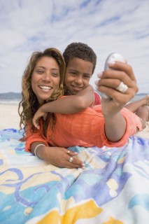 Mother and son taking self portrait on the beach