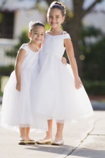 Multi-ethnic flower girls hugging