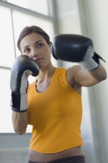 Mixed race woman boxing