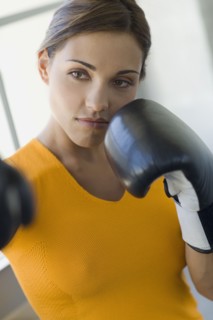 Mixed race woman boxing