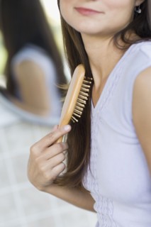Hispanic woman brushing her hair