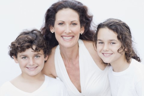 Mother posing with son and daughter for portrait