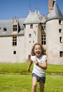 Hispanic girl running with castle in background
