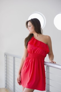 Glamorous Hispanic woman leaning on railing