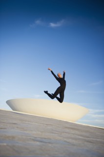 Brazilian dancer jumping in mid-air outdoors