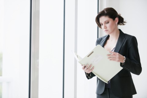 Cuban businesswoman looking at report