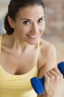 Hispanic woman exercising with dumbbells