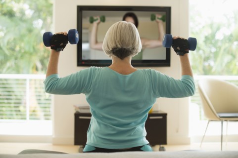 Caucasian woman exercising with hand weights