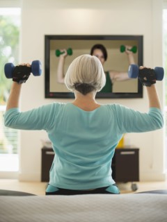 Caucasian woman exercising with hand weights