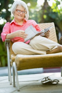 Caucasian woman reading magazine outdoors