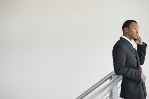 Mixed race businessman talking on cell phone