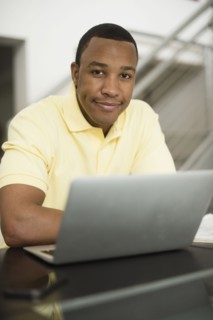 Mixed race businessman using laptop