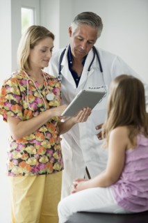 Hispanic girl having checkup in doctor's office