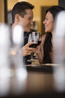 Couple toasting with red wine in restaurant