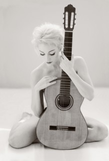 Nude Cuban woman holding guitar