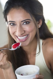 Indian woman eating fruit