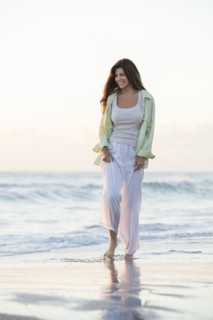 Caucasian woman walking on beach