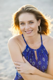 Hispanic woman smiling on beach