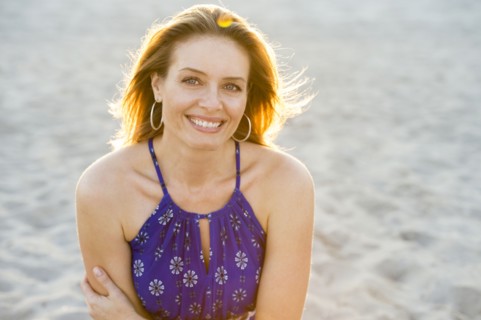 Hispanic woman smiling on beach