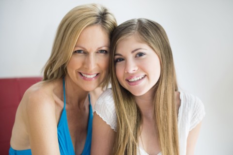 Caucasian mother and daughter smiling together