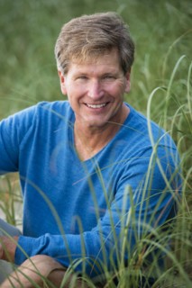 Caucasian man sitting in tall grass